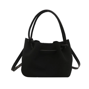 Minimalist black matte tote bag with knotted handles and a large capacity for daily commute