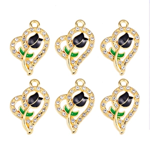 Macro view of heart-shaped pendants with black tulip enamel and sparkling crystals