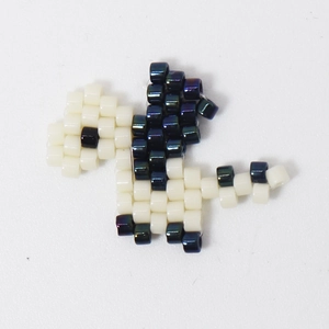 Handmade Miyuki seed bead dinosaur charm in cream and metallic blue for jewelry making