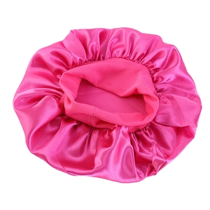 Detailed top view of bright pink satin sleep cap with elastic wide band and silky texture