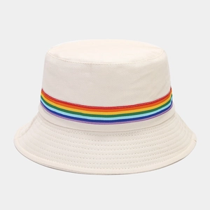 Detail of off-white bucket hat showing rainbow striped ribbon and twill fabric texture