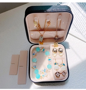 Macro detail of portable jewelry box with necklace hooks and velvet ring organizer