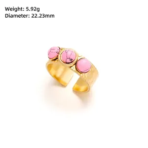 Detail showing gold titanium ring weight 5.92g and dimensions of pink stone inlays