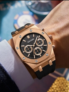 Close-up of rose gold multifunctional sports watch with black rubber strap on wrist