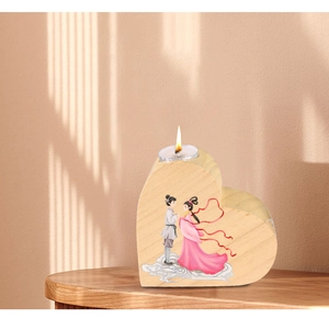 Detail of heart-shaped wooden candle holder with ancient character illustration on wood table