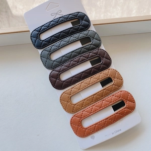 Detailed set of 5 PU leather hair clips in earth tones with quilted diamond texture