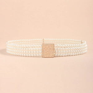 Close-up of a multi-strand pearl belt featuring a gold square buckle with shimmering rhinestones