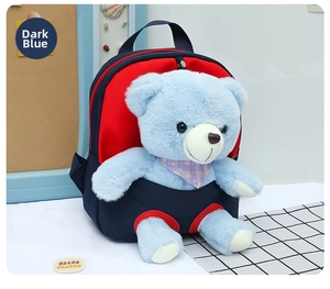 Detail of dark blue kids backpack featuring a cute plush bear with a plaid scarf