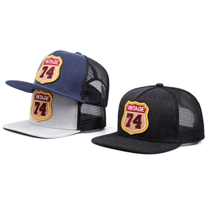 Three colors of vintage 74 mesh trucker hats stacked together with retro cloth patches