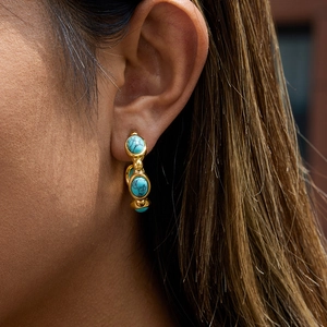 Detail of 18K gold plated stainless steel C-hoop earring with turquoise stones on model