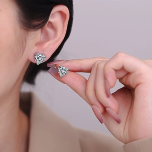 Sparkling heart-shaped zircon stud earrings in elegant silver claw setting for women