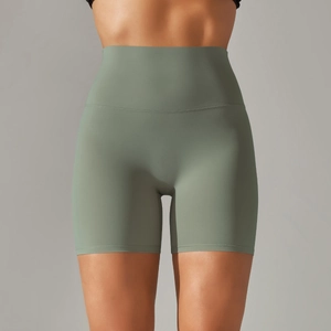 Detail of high-waist sage green yoga shorts with seamless hem and soft brushed fabric