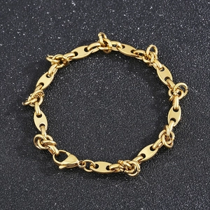 Detailed shot of golden titanium steel coffee bean chain necklace with lobster clasp