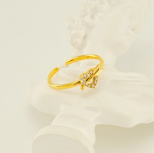 Macro shot of Cupid's arrow ring with heart zircon inlay on classic plaster statue