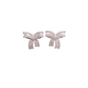 Silver bow stud earrings featuring sparkling baguette and round cut cubic zirconia stones