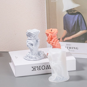 Detail of DIY silicone mold showing intricate rose hand and skull base for wax crafting