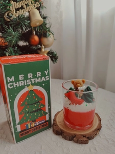 Detail of Christmas strawberry chocolate candle with bear and tree topper in a gift box