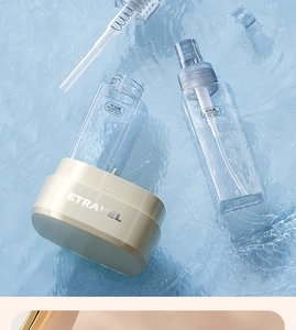 Close-up of portable travel bottles for shower gel in clear water with ripples