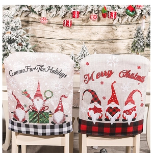 Detail of Christmas gnome chair covers with Merry Christmas text and plaid patterns