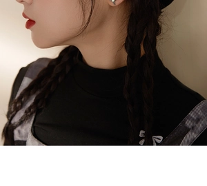 Close-up of 925 silver angel and demon stud earrings with pearls and vintage finish