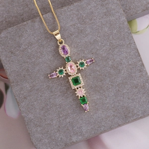 18K gold plated cross pendant necklace featuring colorful zircon stones on stone background