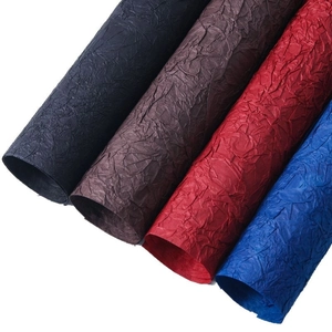 Textured stone-patterned wrapping paper rolls in black, red, blue, and brown colors