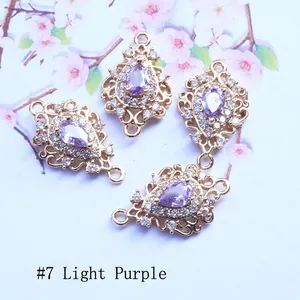 Detail of light purple teardrop zircon charms with gold hollow frame for DIY jewelry