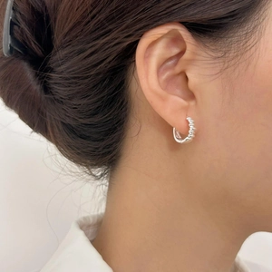 Elegant 925 sterling silver twist hoop earrings on a model showing minimalist style