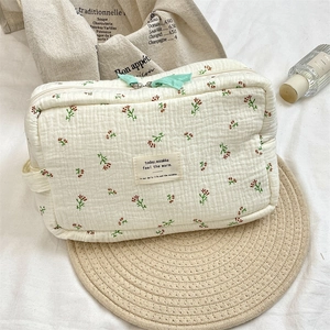 Detail of floral pattern texture and fabric label on a portable cosmetic storage bag