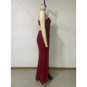 Close-up of red sequined evening gown featuring elegant long fringe details and slim fit design