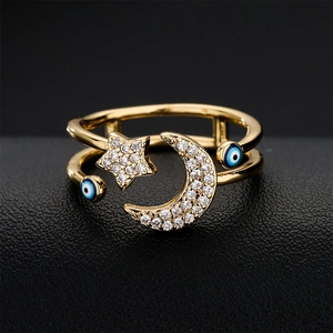 Gold star and moon open ring with blue evil eye charms and sparkling zircon pavé
