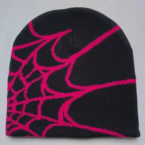 Close-up of the knitted beanie texture showing the hot pink spider web pattern details