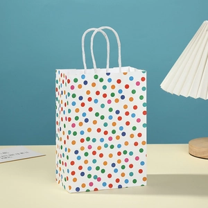 White paper gift bag with colorful polka dots and white rope handles for celebrations