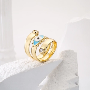Detailed macro view of 18K gold-plated triple layer evil eye ring with blue enamel inlay