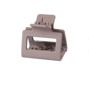 Detail shot of a square matte taupe hair claw clip with a hollow design and sturdy teeth