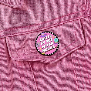 Detail of Horror Movie Lover enamel pin on pink denim jacket with witch movie theme