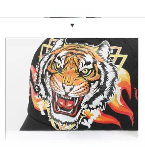 Close-up of tiger head print on black mesh quick-dry cap with flame design details