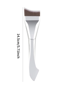 Macro detail of crescent angled foundation brush with synthetic bristles and silver handle