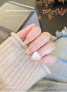 Detailed close-up of 3D white plush heart nail charms on a gradient manicure