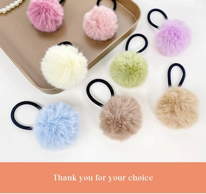 Detail of plush pompom hair ties in pastel colors with high elasticity rubber bands