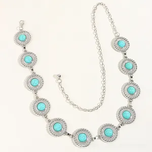 Close-up of vintage silver chain belt featuring turquoise stone inlays and boho patterns