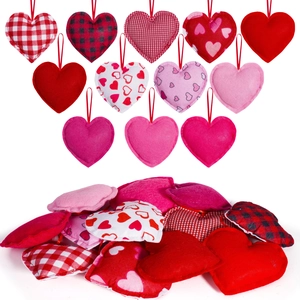 Detail of diverse heart-shaped fabric ornaments with red hanging strings for Valentine decor