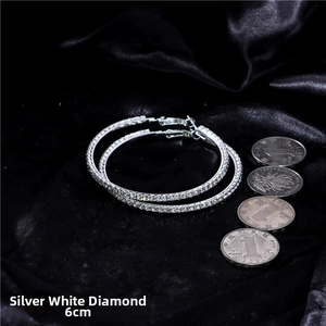 Detail of 6cm silver oversized crystal hoop earrings with white rhinestones on black silk
