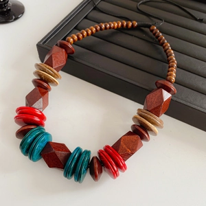 Detailed view of bohemian necklace with faceted wood and coconut beads in rich earthy tones