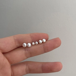 Macro shot showing size comparison of smooth round freshwater pearls for jewelry DIY