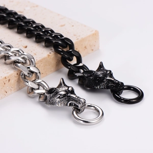 Macro shot of silver and black wolf head pendant with thick chunky cuban link chain