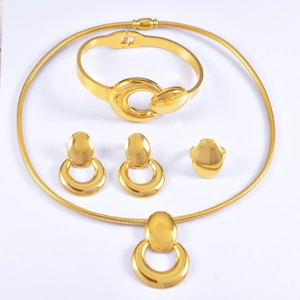 Polished gold jewelry set including snake chain necklace, bangle, earrings and ring