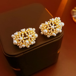 Macro di orecchini con perle vintage su scatola porta gioie in pelle nera