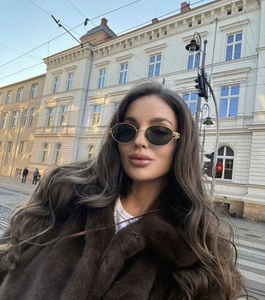 Detailed view of women's brown long-hair faux fur coat with stylish lapel collar