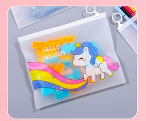 Close-up of a translucent unicorn zipper pouch holding colorful building blocks
